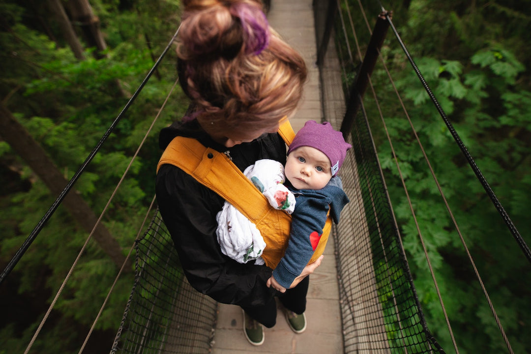 mom holding baby in carrier