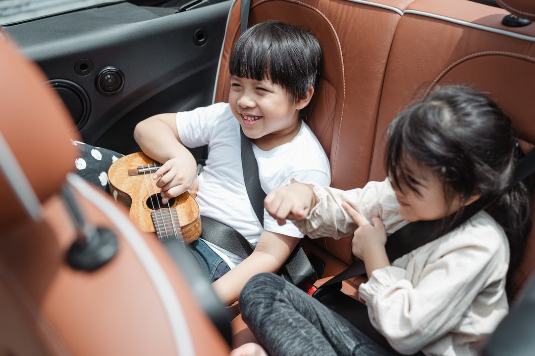 children sitting on the backseat