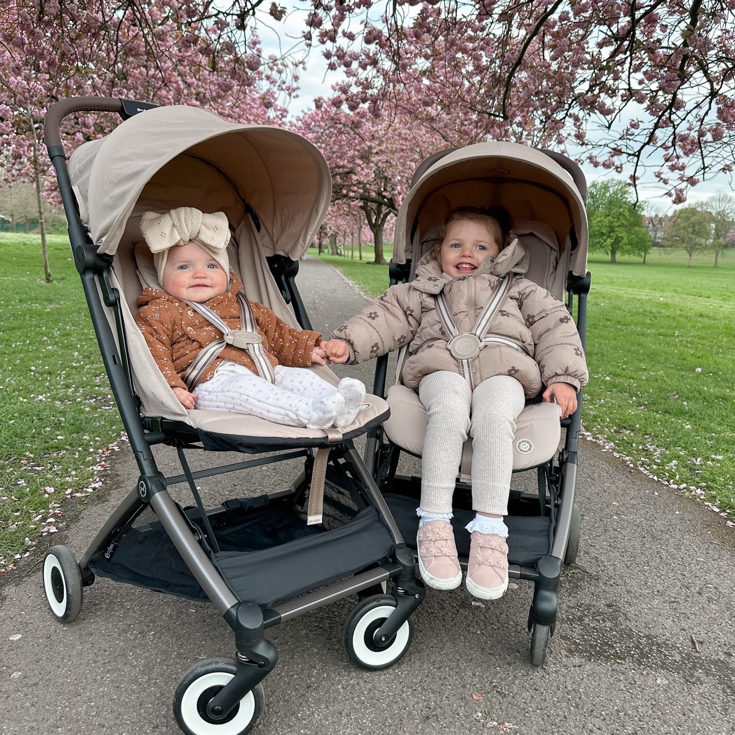 two little girls in trollers, outdoors