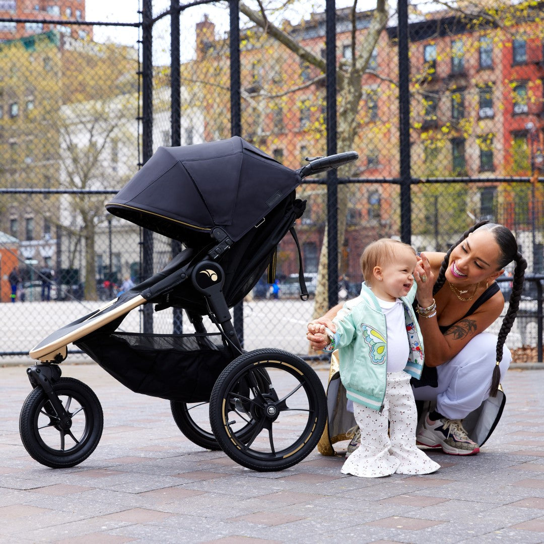 mother and daughter with travel system