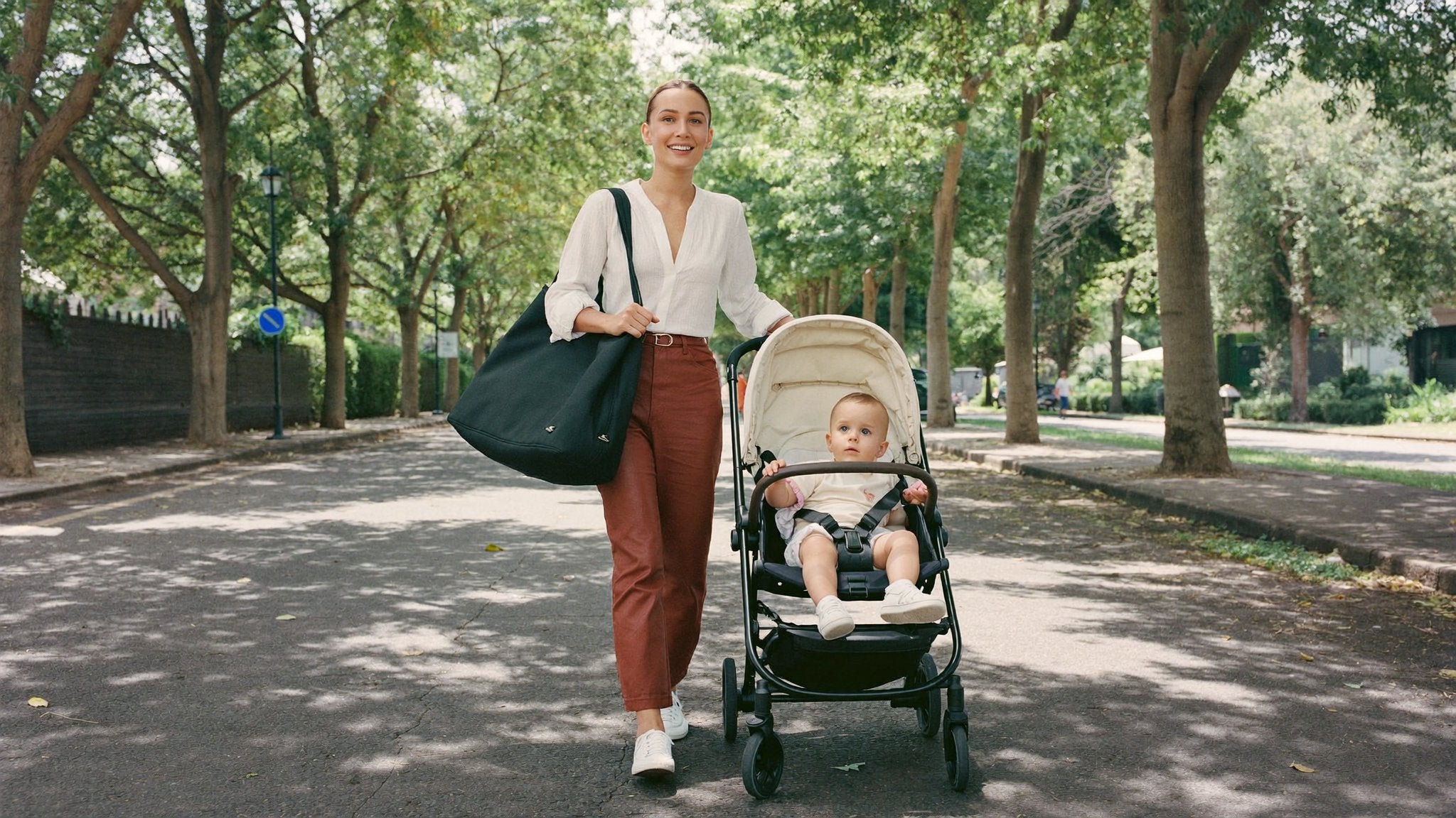 Mother with a changing bag beside the pushchair - Bambinos & Beyond Changing Bags