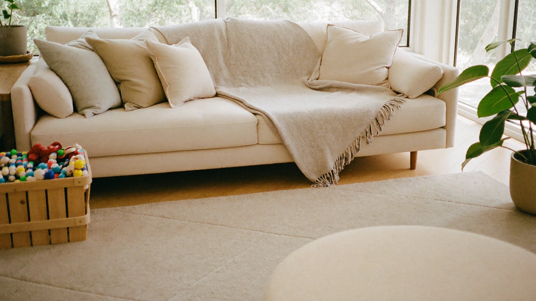 Bright cosy family living room with soft neutral homeware - Bambinos & Beyond For The Home