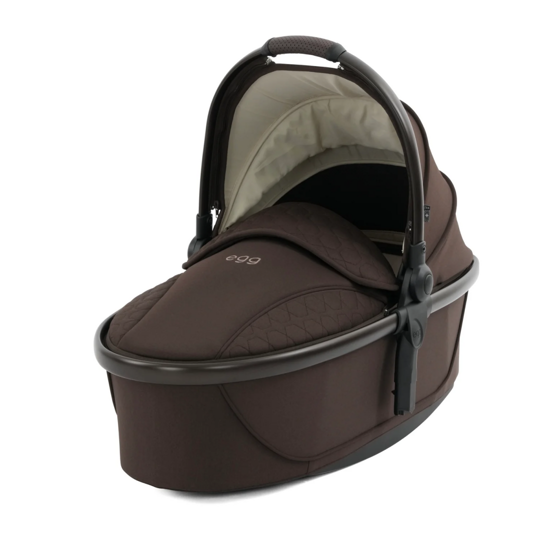 Brown baby carrier with 'egg' branding on a white background