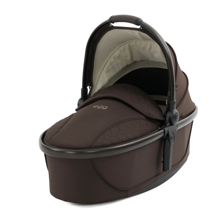 Brown baby carrier with 'egg' branding on a white background