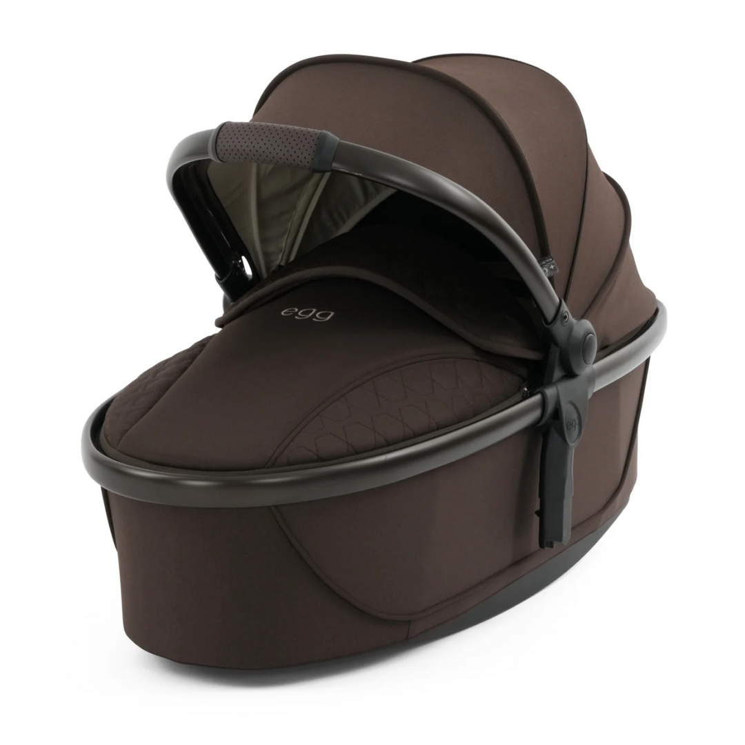 Brown baby carrier with 'egg' branding on a white background