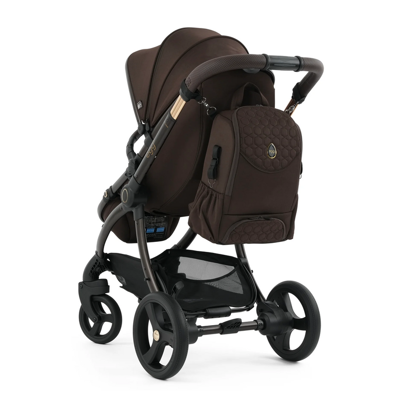 Brown baby stroller with matching backpack on a white background